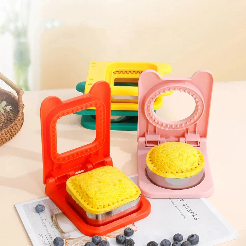 Crustless Sandwich Cutter & Sealer on kitchen counter with filled and cut crustless shaped sandwiches