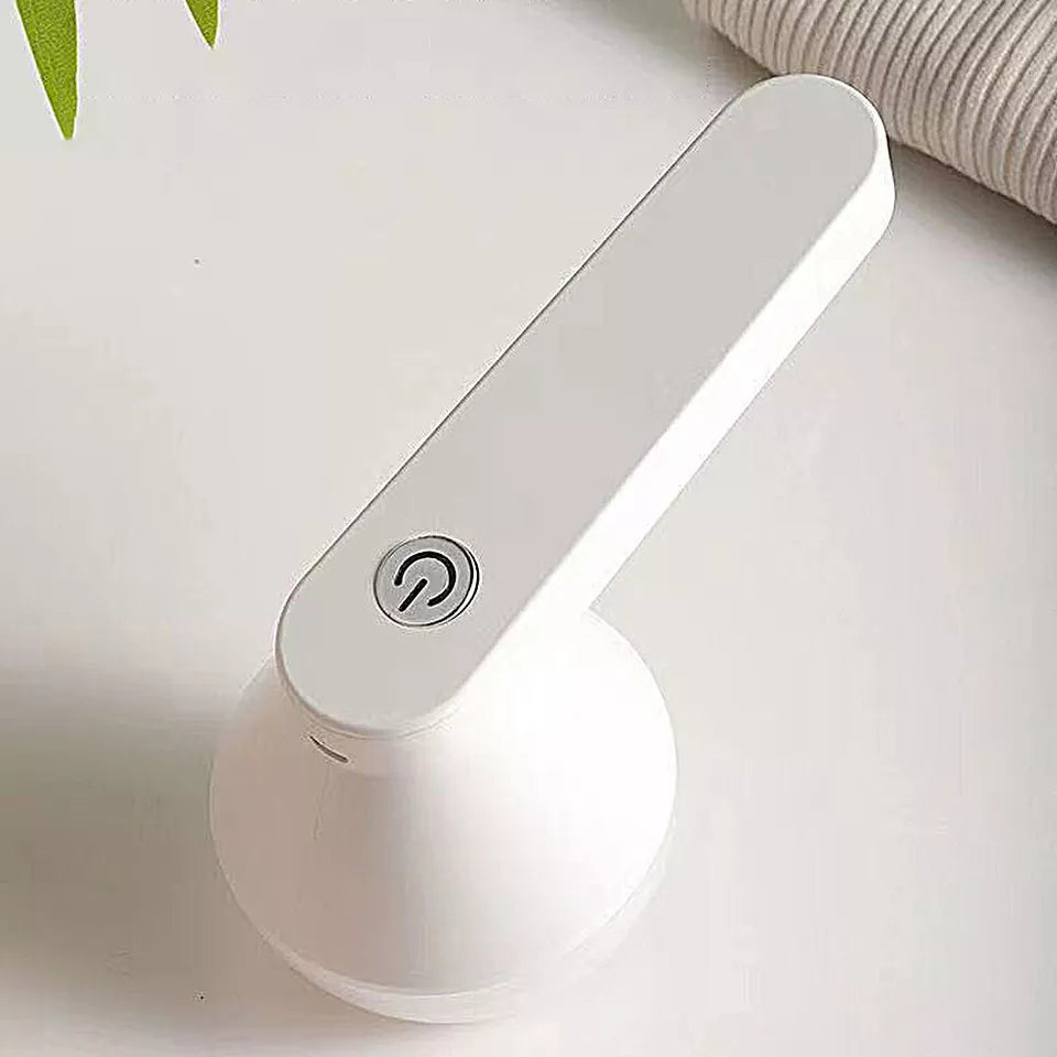 Easy-to-Use Fabric Shaver and Lint Remover on bathroom counter ext to sweater