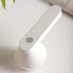 Easy-to-Use Fabric Shaver and Lint Remover on bathroom counter ext to sweater