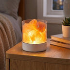 Himalayan Salt Lamp glowing on night stand in bedroom
