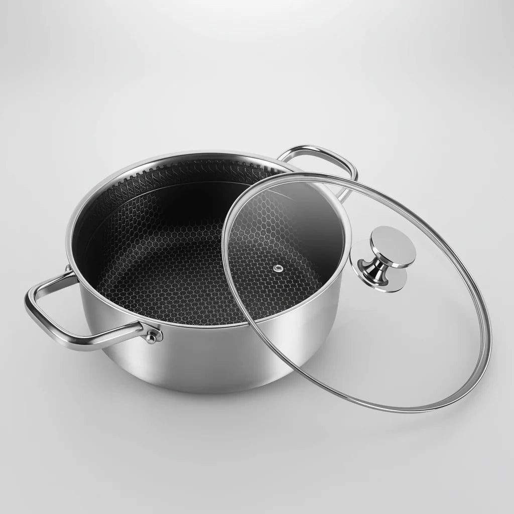 Stainless steel pot with a glass lid on a light gray background